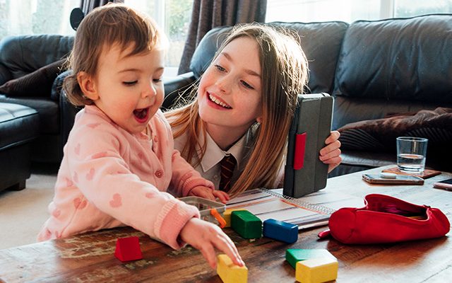 foster siblings playing with blocks at coffee table