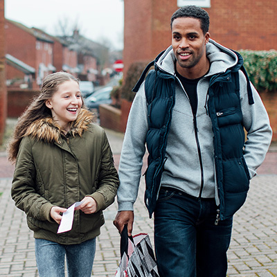 foster child with foster dad walking