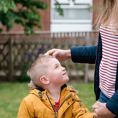 foster child holds hands with foster mum