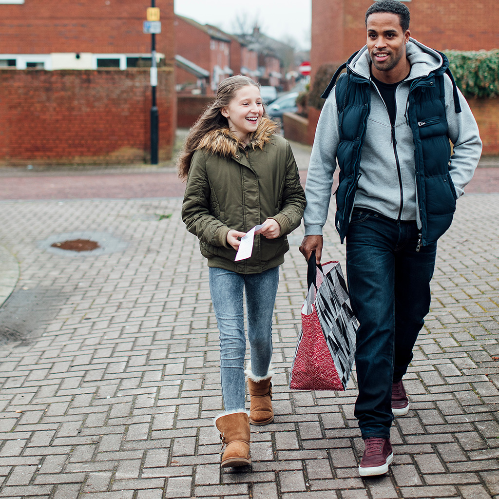 foster child with foster dad walking